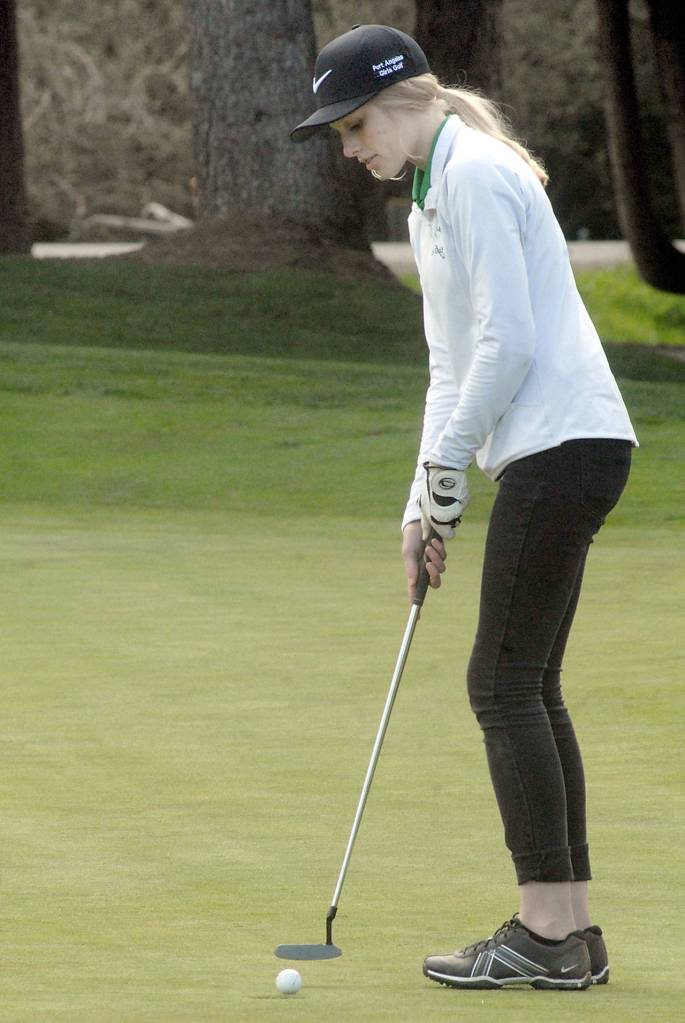 Keith Thorpe/Peninsula Daily News Tana Hiigel of Port Angeles putts on the first hole at the Cedars at Dungeness near Sequim on Wednesday.