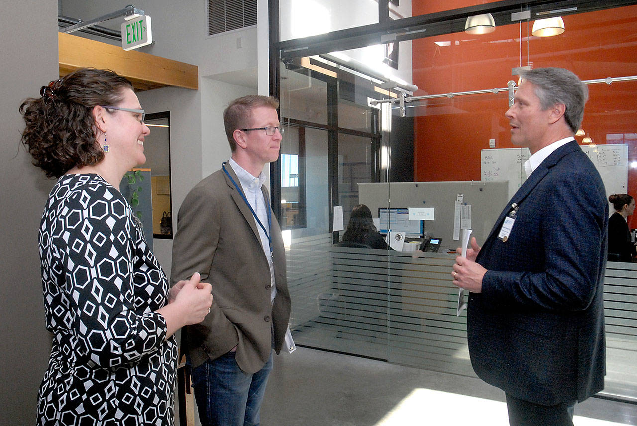 U.S. Rep. Derek Kilmer, center, tours the Port Angeles clinic of the North Olympic Healthcare Network on Friday with Kate Weller, the center&rsquo;s chief medical officer, and CEO Michael Maxwell. (Keith Thorpe/Peninsula Daily News)