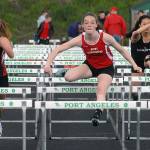 Keith Thorpe/Peninsula Daily News Port Townsend&rsquo;s Aubry Botkin, center, pulls ahead of competitors Lindey Roberts of Coupville, left, and Shayli Schuman of Sequim, right, to win the girls 100 meter hurdles.