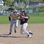 Steve Mullensky/for Peninsula Daily News                                Port Townsend&rsquo;s Travis McComaghy takes it on the chin as he&rsquo;s tagged out by Forks&rsquo; third baseman, Billy Palmer, during a game in Port Townsend on Monday.