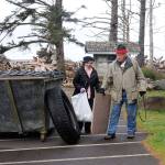 Beverly Rosenow and Francis Brophy of Port Townsend with the Mountaineers deposit trash at the Rialto Beach parking lot during a beach cleanup. (Lonnie Archbald/for Peninsula Daily News)