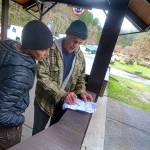 Dani Campbell and Randy Gray look over a map over the area surrounding the Sol Duc River on Wednesday as they prepare to look for Gray&rsquo;s son, Jacob Gray, an avid outdoorsman who disappeared in Olympic National Park on April 6. (Jesse Major/Peninsula Daily News)