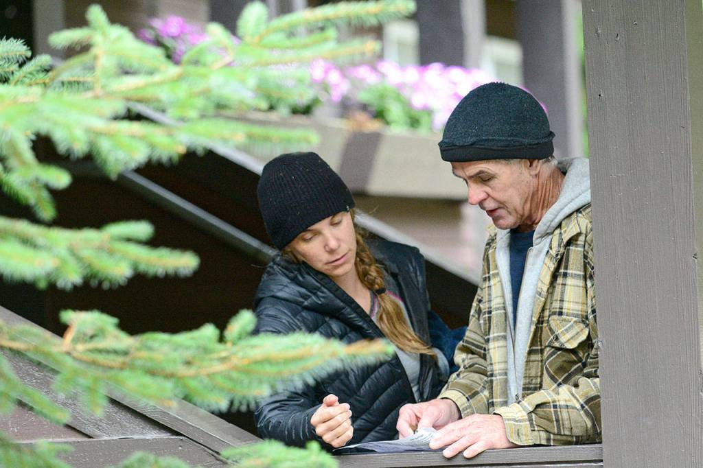 Dani Campbell and Randy Gray look over a map over the area surrounding the Sol Duc River on Wednesday as they prepare to look for Gray&rsquo;s son, Jacob Gray, an avid outdoorsman who disappeared in Olympic National Park on April 6. (Jesse Major/Peninsula Daily News)