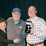 Deputy Don Kitchen, right, poses with Sue Chasen, left, and Larry Buzzell at the ceremony where Kitchen received an award for his actions in saving Buzzell&rsquo;s life.