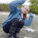 Blue Heron eighth-grader Gracie Hoffman studies a water sample taken from the south side of Indian Island for a two-day class project to collect data from the water in the area. (Cydney McFarland/Peninsula Daily News)