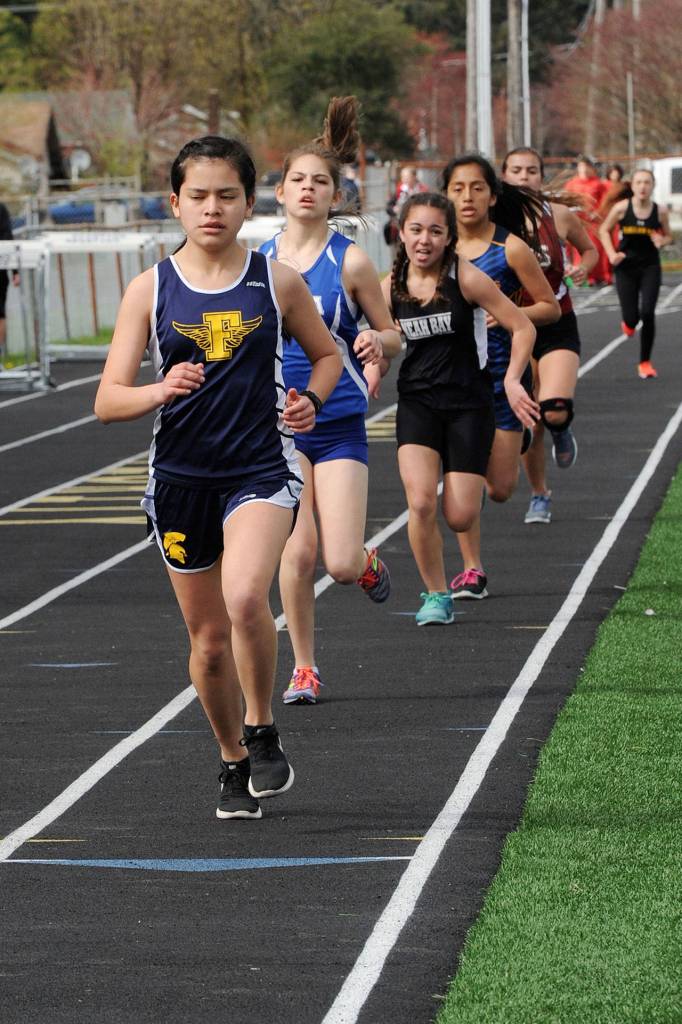 Lonnie Archibald/for Peninsula Daily News Forks runner Enid Ensastegui leads the pack of girls representing Elma, Neah Bay, Hoquiam, and Clallam Bay in the 3,200-meter run. Ensastegui won the race.