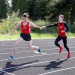 Steve Mullensky/for Peninsula Daily News                                Port Townsend&rsquo;s Seren Dances takes the baton from teammate Berkley Hill and runs the anchor leg of the boys 4X200 relay race during a meet at Blue Heron Middle School on Friday. The team, consisting of Dances, Hill, Gerry Coker and Kyle Blankenship, went on to set an new school record in the race with at time of 1:33.49.