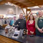 Quimper Mercantile employees Ken Hulick, Sereta Rondeau and Sheldon Spencer, from left, prepare for a busy Sunday, which will be the first day of a community giving program where a percentage of sales will go to local schools. (Cydney McFarland/Peninsula Daily News)