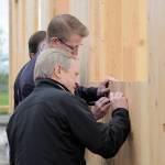 State Rep. Steve Tharinger, foreground, and U.S. Rep. Derek Kilmer put their signature on a cross-laminated timber modular building being built on the Greywolf Elementary School campus. (Michael Dashiell/Olympic Peninsula News Group)