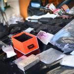 Guns, money, cellphones, heroin and methamphetamine sit on the hood of the car Clallam County Sheriff&rsquo;s deputies searched Sunday. (Jesse Major/Peninsula Daily News)