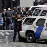 Police officers crowd a street adjacent to the scene of a shooting involving several police officers in downtown Seattle on Thursday. (Elaine Thompson/The Associated Press)