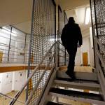 A corrections deputy walks to the upper level of a unit of the Pierce County Jail in Tacoma on Oct. 15, 2014. (Elaine Thompson/The Asociated Press)