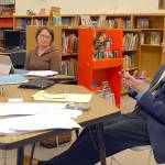 Crescent School Board members Susan Hopper, left, and Board President Trish Haggerty, center, listened to a presentation Thursday by schools Superintendent Dave Bingham. (Paul Gottlieb/Peninsula Daily News)