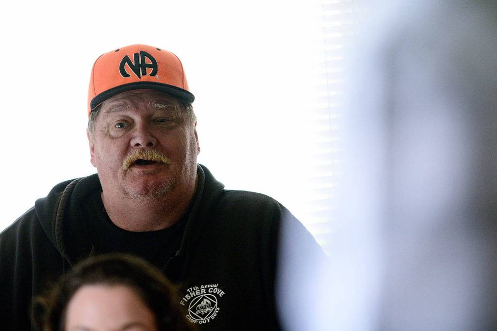Eric Simms, a Port Angeles Oxford House resident, talks about outreach efforts during the monthly chapter meeting. (Jesse Major/Peninsula Daily News)
