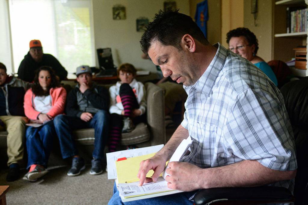 Chad Westenhaver, chair of the Port Angeles Oxford House chapter, leads the group&rsquo;s monthly meeting. (Jesse Major/Peninsula Daily News)