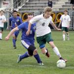 By Dave Logan/for Peninsula Daily News Port Angeles&rsquo; Ben Schneider (6) fends off North Mason&rsquo;s Richard Miller in the Roughriders&rsquo; 6-0 win Monday night at Civic Field. The win keeps the Riders in good position for a playoff slot.