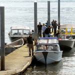 Keith Thorpe/Peninsula Daily News                                Halibut anglers line up at one of two docks on Ediz Hook in Port Angeles waiting to be hauled out on Thursday.