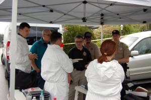 Representatives with the Clallam County Sheriff&rsquo;s Office and Coroner&rsquo;s Office investigate the death of Cynthia Little in Sunland on Thursday. (Matthew Nash/Olympic Peninsula News Group)
