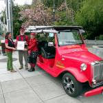 Port Townsend Main Street board member Connie Segal, left, delivers the &ldquo;Sustainable Future&rdquo; award to Myron Gauger and Kate Dwyer, owners of PT eRider. (Mari Mullen)