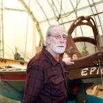 Henry Hazen, a 2017 Heart of Service Award recipient, stands by the 30-foot-long boat, EPIC, that he helped construct by mentoring students at Community Boat Project in Port Hadlock. (Steve Mullensky/for Peninsula Daily News)