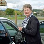 Joni Williams puts bags of food in her car for delivery to the Backpacks for Kids Program at the YMCA in Port Townsend. (Steve Mullensky/for Peninsula Daily News)