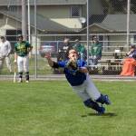 Steve Mullensky/for Peninsula Daily News Chimacum catcher, Lane Dotson, dives for a pop-up during a play-off game against Vashon on Saturday in Chimacum.