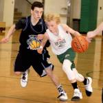 Dave Logan/for Peninsula Daily News Port Angeles&rsquo; Dru Clark drives past a Courtenay, B.C. Yetis&rsquo; defender in eighth-grade action at this weekend&rsquo;s MayDay Roundball Tournament in Port Angeles. Port Angeles won the game 50 to 40.
