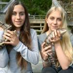 Port Townsend sisters, from left, Lauren and Grace Taracka hold two of their pet reptiles. Lauren started a business, Lizardopolis, which visits local schools and events to educate kids about reptiles and amphibians. (Cydney McFarland/Peninsula Daily News)
