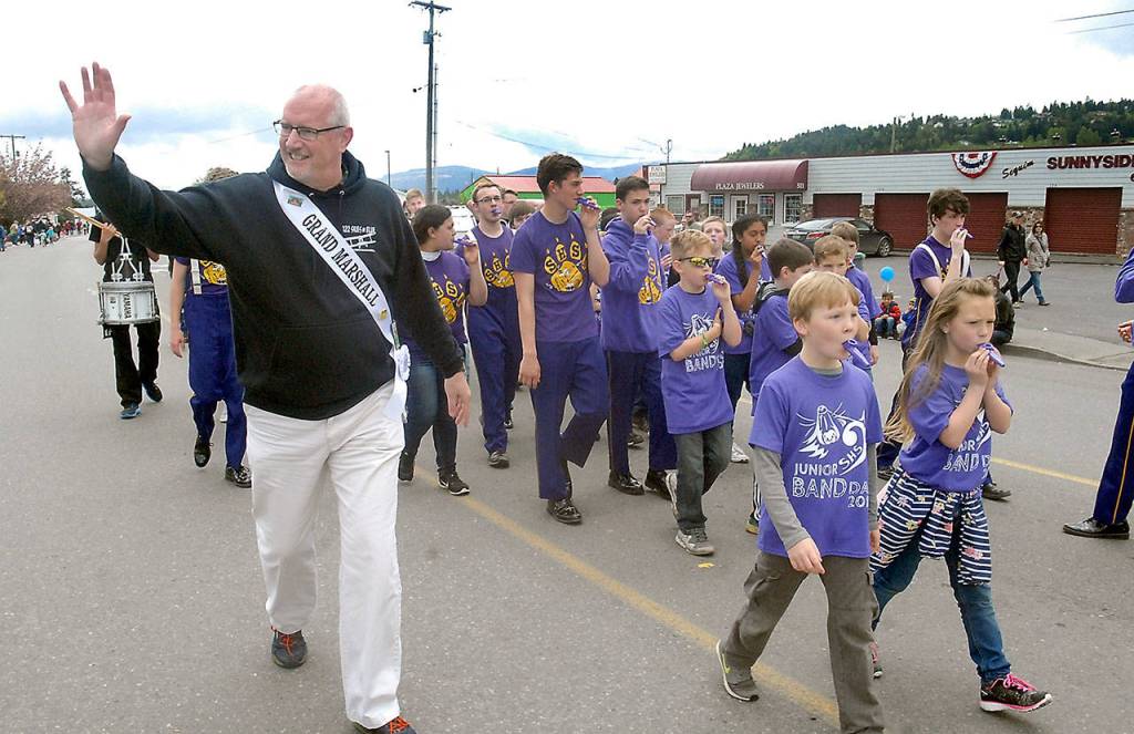 Sequim High School band director Vern Fosket, left, the grand marshal for the Irrigation Festival Grand Parade, marches with a kazoo band of Sequim school students. (Keith Thorpe/Peninsula Daily News)