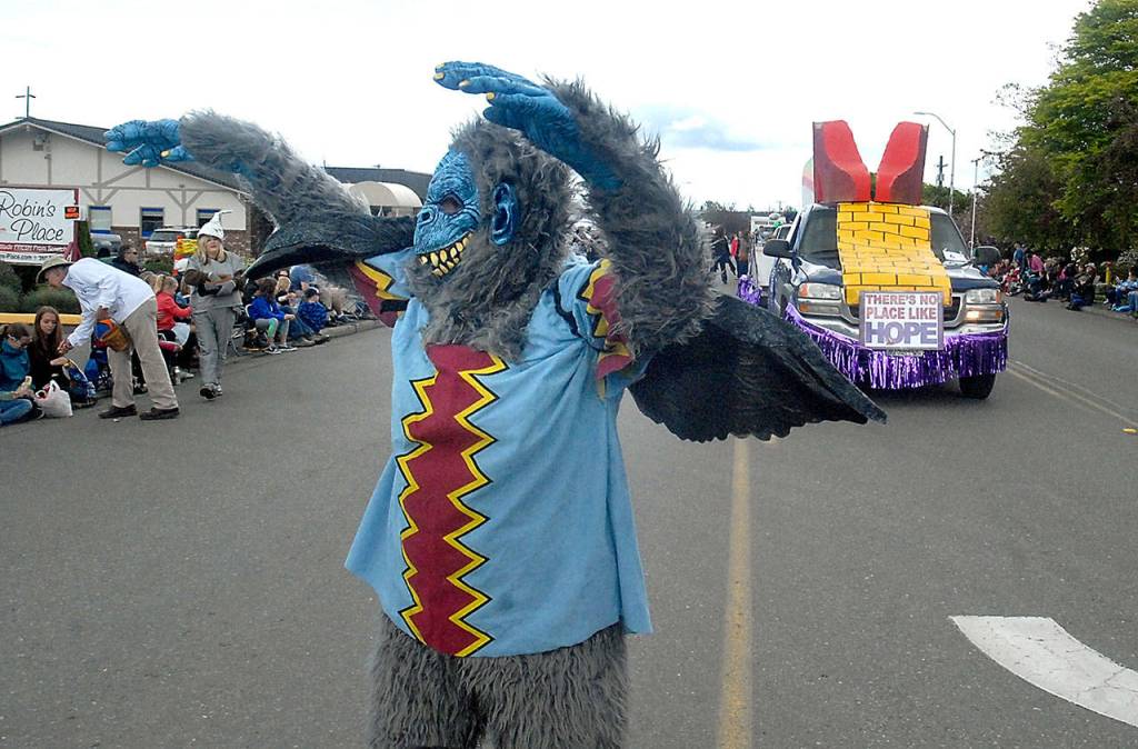 Carla Madison, dressed as a flying monkey character from &ldquo;The Wizard of Oz&rdquo; entertains parade-goers Saturday. (Keith Thorpe/Peninsula Daily News)