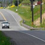 A vehicle crosses the McDonald Creek bridge on Old Olympic Highway near Agnew. (Keith Thorpe/Peninsula Daily News)