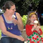 Danielle DeOliveira of Port Angeles and her daughter, Mara Jordan, 5, enjoy ice-cream cones from the food court at the Juan de Fuca Festival on Saturday. (Keith Thorpe/Peninsula Daily News)