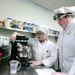 Senior Jasmine White and junior Cassy Reese prepare to bake bagels during their culinary class at the North Olympic Peninsula Skills Center on Tuesday. (Jesse Major/Peninsula Daily News)
