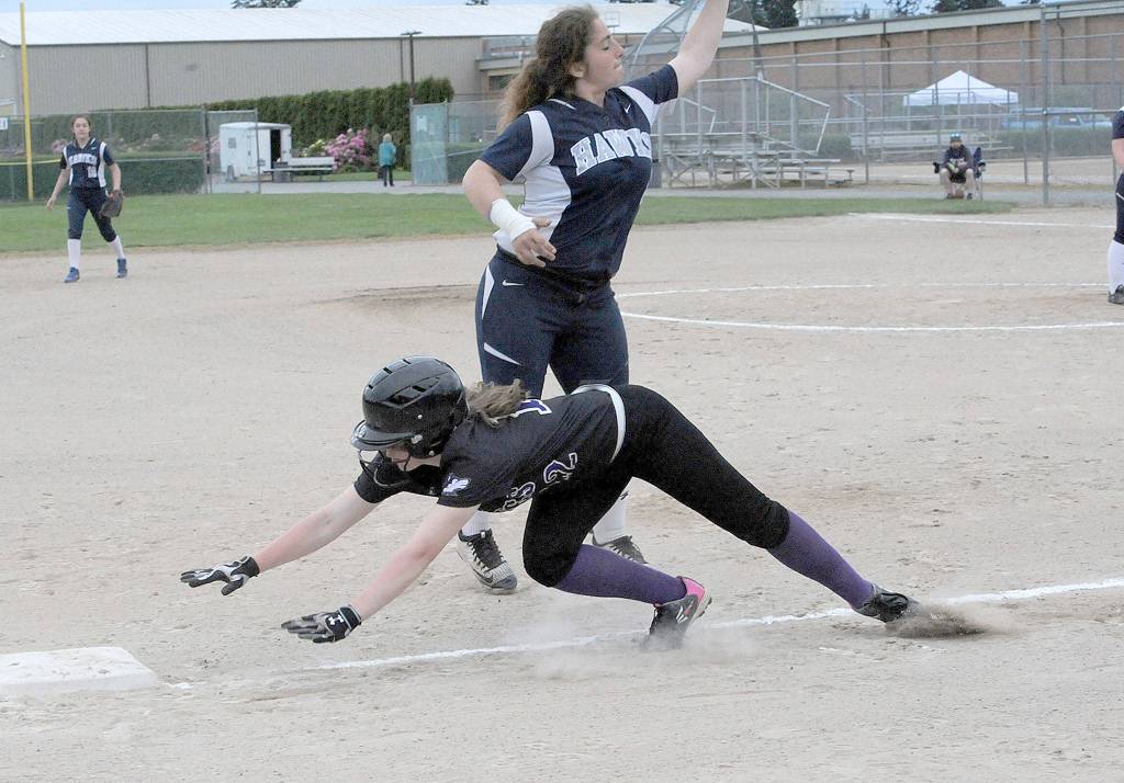Lonnie Archibald/for Peninsula Daily News Sequim&rsquo;s Maddison Nute dives back to third base to beat a throw to River Ridge third baseman Ahtumn Tomkins during Sequim&rsquo;s 7-0 win Friday.                                Lonnie Archibald/for Peninsula Daily News Sequim&rsquo;s Adrienne Haggerty is called out on a slide at third base against Olympic Saturday. The Wolves won the game 9-1 to qualify for the State 2A softball tournament. Haggerty hit a solo home run in the win.