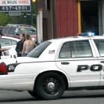 Port Angeles Police Officer Brian Stamon, left, and Sgt. Kori Malone interview a witness to an armed robbery Friday afternoon at The Daily Grind coffee stand at 1919 E. First St. in Port Angeles. (Keith Thorpe/Peninsula Daily News)