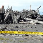Clallam County Sheriff&rsquo;s Deputy Michael Leiter looks over a driftwood structure near the spot where an unignited military marker flare was discovered near the mouth of the Elwha River west of Port Angeles on Friday. (Keith Thorpe/Peninsula Daily News)