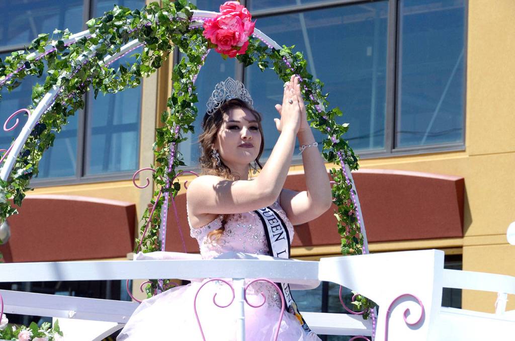 Rhody Queen Lauren Montgomery waves from a float in the Rhody Grand Parade in Port Townsend on Saturday. (Cydney McFarland/Peninsula Daily News)