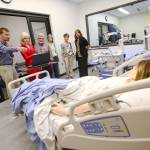 A group tours Peninsula College&rsquo;s Allied Health and Early Childhood Education Building during its grand opening Monday. (Jesse Major/Peninsula Daily News)