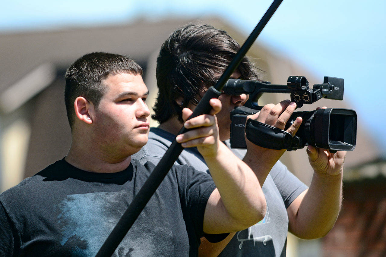 Sophomores Bradley Shumway, left, and Jordan Campbell film during their cinema and TV production class at the North Olympic Peninsula Skills Center on Wednesday. (Jesse Major/Peninsula Daily News)