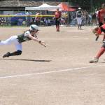 Port Angeles&rsquo; Sierra Robinson dives safely into third base as Othello&rsquo;s Audisey Sauceda covers the base. The Roughriders won the game 1-0 as part of three straight shutouts at the State 2A Softball Tournament. (Lonnie Archibald/for Peninsula Daily News)