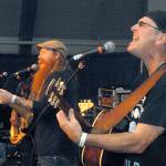 Jonny Mojo, left, and Paul Kamm, leaders of the Northern California-based Achilles Wheel, entertain the audience on the Main Stage of the Juan de Fuca Festival on Friday. (Keith Thorpe/Peninsula Daily News)