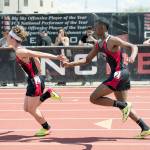 Casey Bruner/for Peninsula Daily News Neah Bay&rsquo;s Anthony Bitegeko hands the baton to Logan Halttunen in the preliminaries of the 4x100 relay at the State 1B Track and Field Championships in Cheney on Friday.