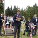 John Kent, Veterans of Foreign Wars Post 1024 commander, at microphone, speaks at a Memorial Day ceremony at Mount Angeles Memorial Park cemetery Monday. Kent is flanked by Korean War veteran Richard Smelling, left; World War II veteran Tom McKeown, right, seated; and other members of VFW Post 1024. (Rob Ollikainen/Peninsula Daily News)