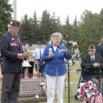 Patricia Foster of Veterans of Foreign Wars Auxiliary 1024 speaks at a Memorial Day ceremony at Mount Angeles Memorial Park cemetery on Monday. She is flanked by Richard Smelling of VFW Post 1024, far left, post Commander John Kent, post Trustee Tom McKeown and post Chaplain Sonja Schimmele. (Rob Ollikainen/Peninsula Daily News )