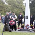 Rod Lee of the Carlsborg VFW, far left, carries a wreath to place at the base of the veterans memorial obelisk during the Memorial Day ceremonies at the Sequim View Cemetery on Monday. (Dave Logan/for Peninsula Daily News)