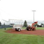 Pierre LaBossiere/Peninsula Daily News                                Darryl Anderson with the Port Angeles Parks and Rec Department lays down the infield clay at Civic Field Tuesday. The field and bleachers are all ready to go for the Lefties opener today.