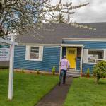 Real estate broker James Pitts III walks up to the fully remodeled childhood home of serial murderer Ted Bundy in Tacoma. (Peter Haley/The News Tribune via AP)