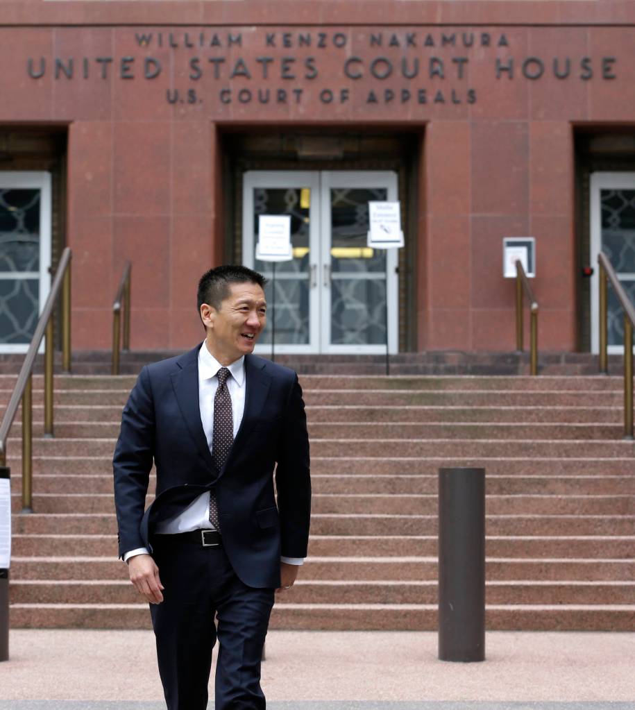Hawaii Attorney General Doug Chin arrives to talk to reporters Monday outside a federal courthouse in Seattle. (Ted S. Warren/The Associated Press)