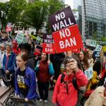 Protesters wave signs and chant during a demonstration against President Donald Trump&rsquo;s revised travel ban Monday outside a federal courthouse in Seattle. (Ted S. Warren/The Associated Press)