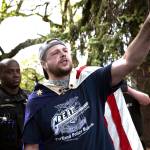 In an April 29 photo provided by John Rudoff, Jeremy Joseph Christian, right, is seen during a Patriot Prayer organized by a pro-Trump group in Portland, Ore. (John Rudoff via AP)